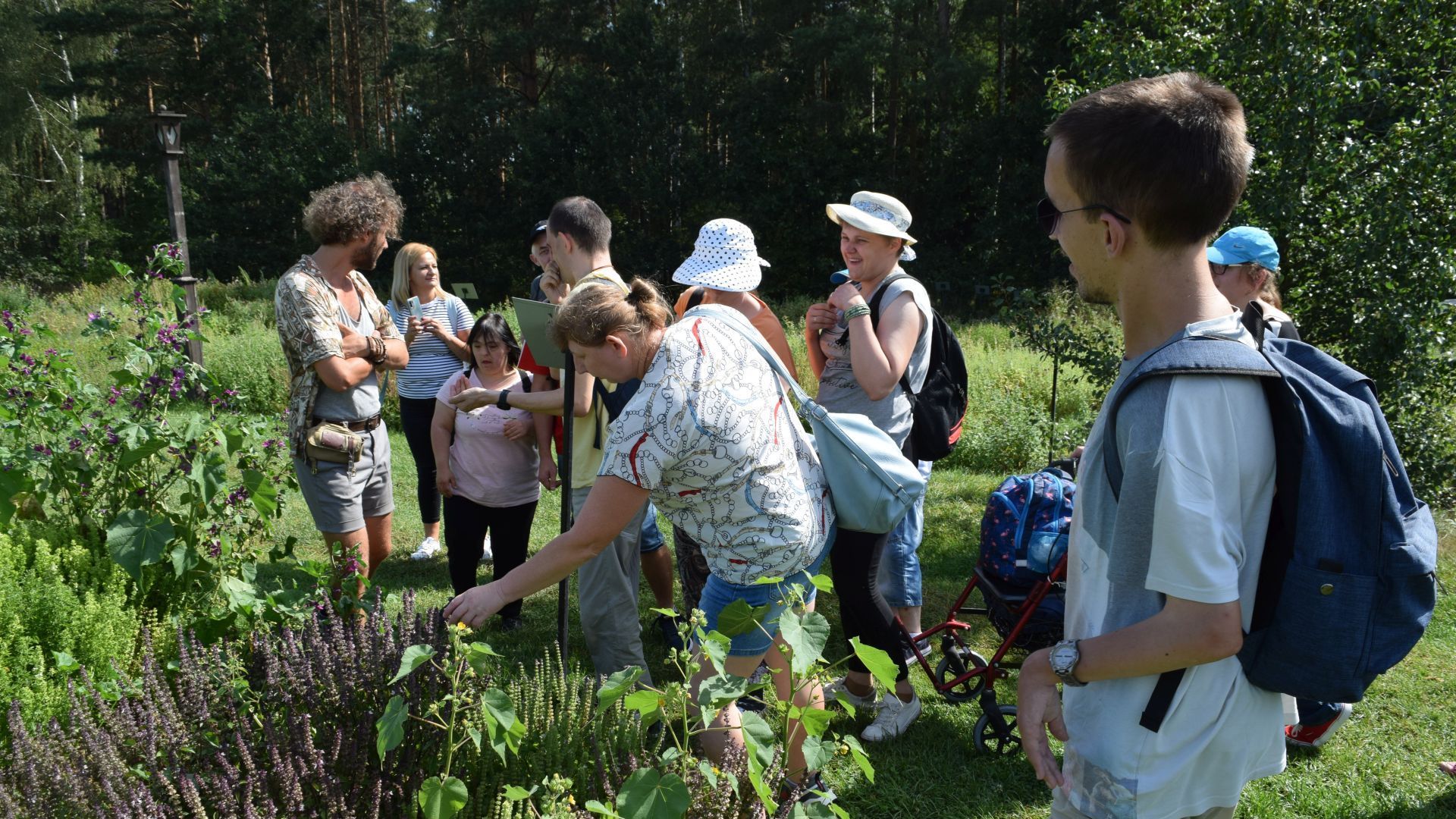 Uczestnicy oglądający rośliny w Ogrodzie Botanicznym. 
