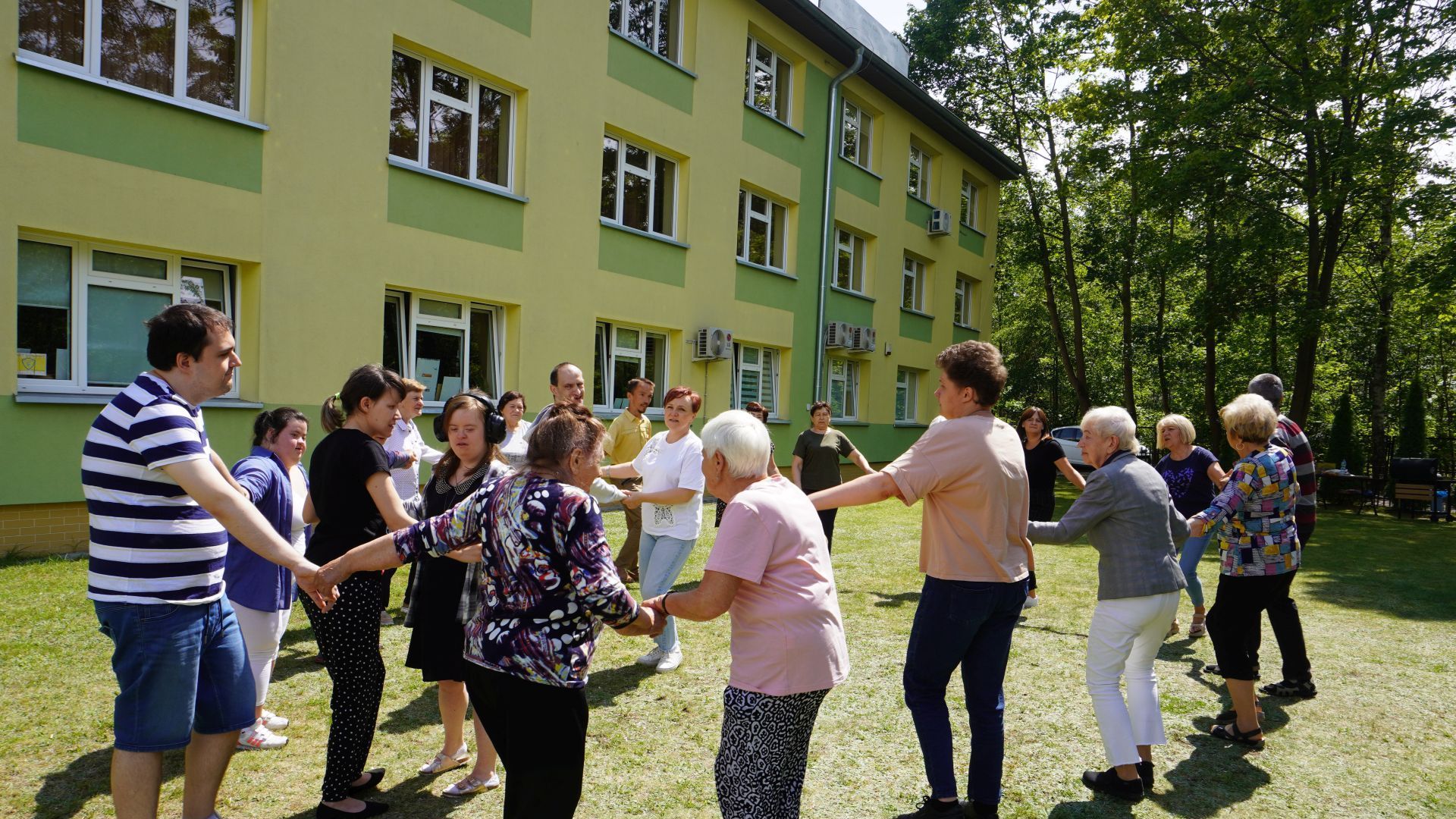 Tańce w kółku podczas grilla podsumowującego projekt ''Jesteśmy dla innych''.